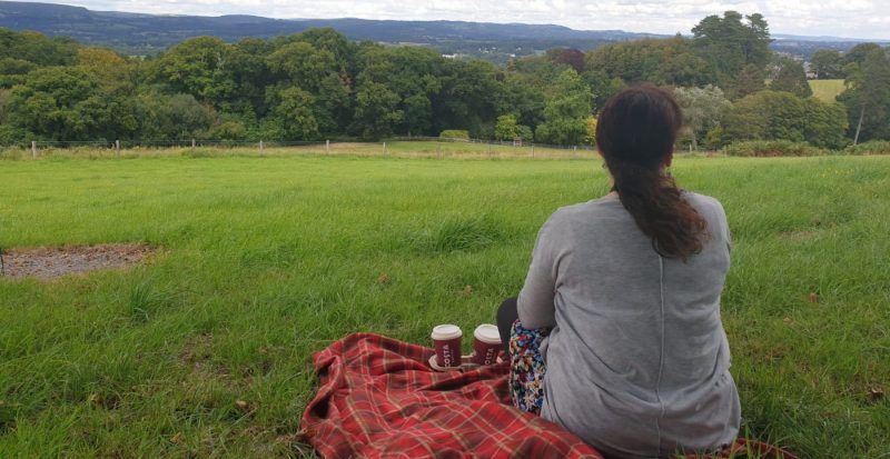 Celebrant sitting at Cardiff Natural Burial Meadow
