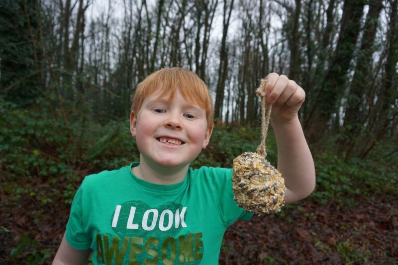 Jesse holding his pine cone bird feeder