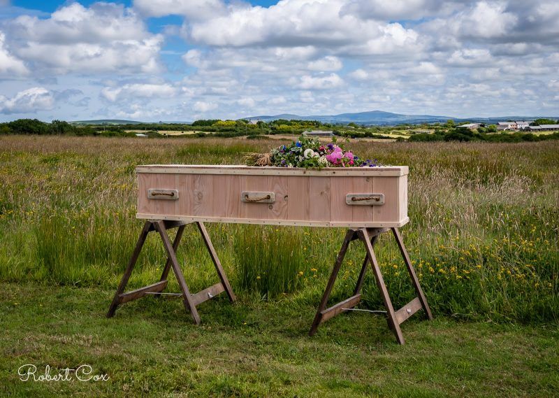 Ecological Coffin on trestles Pembrokeshire Natural Burial Meadow. Photo by Robert Cox.