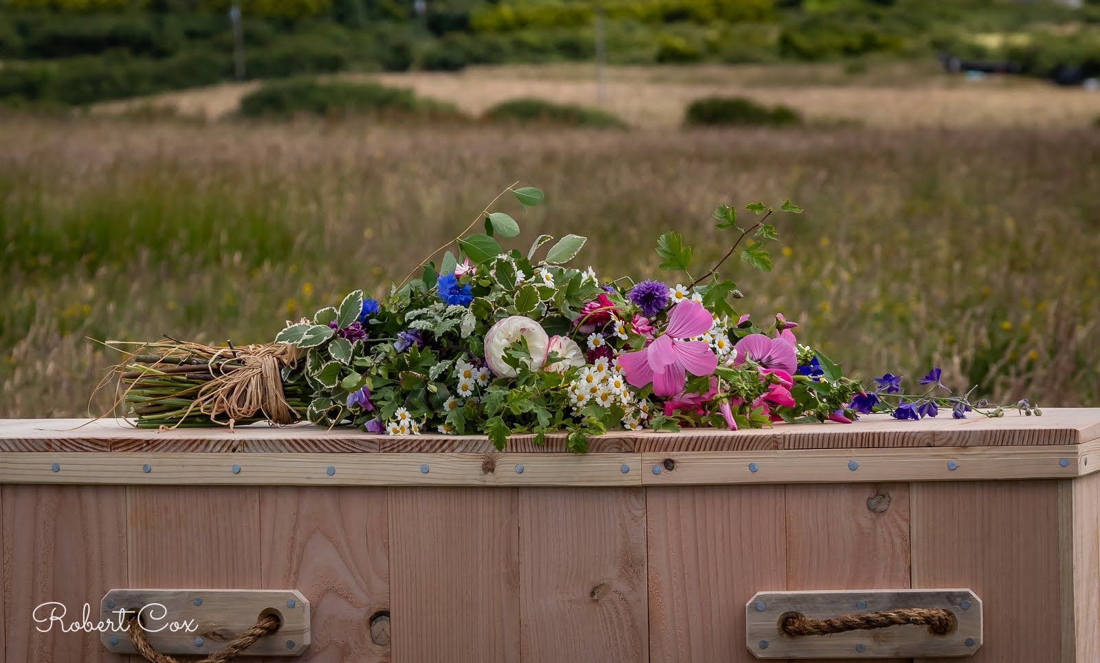 Biodegradable coffin and flower arrangement